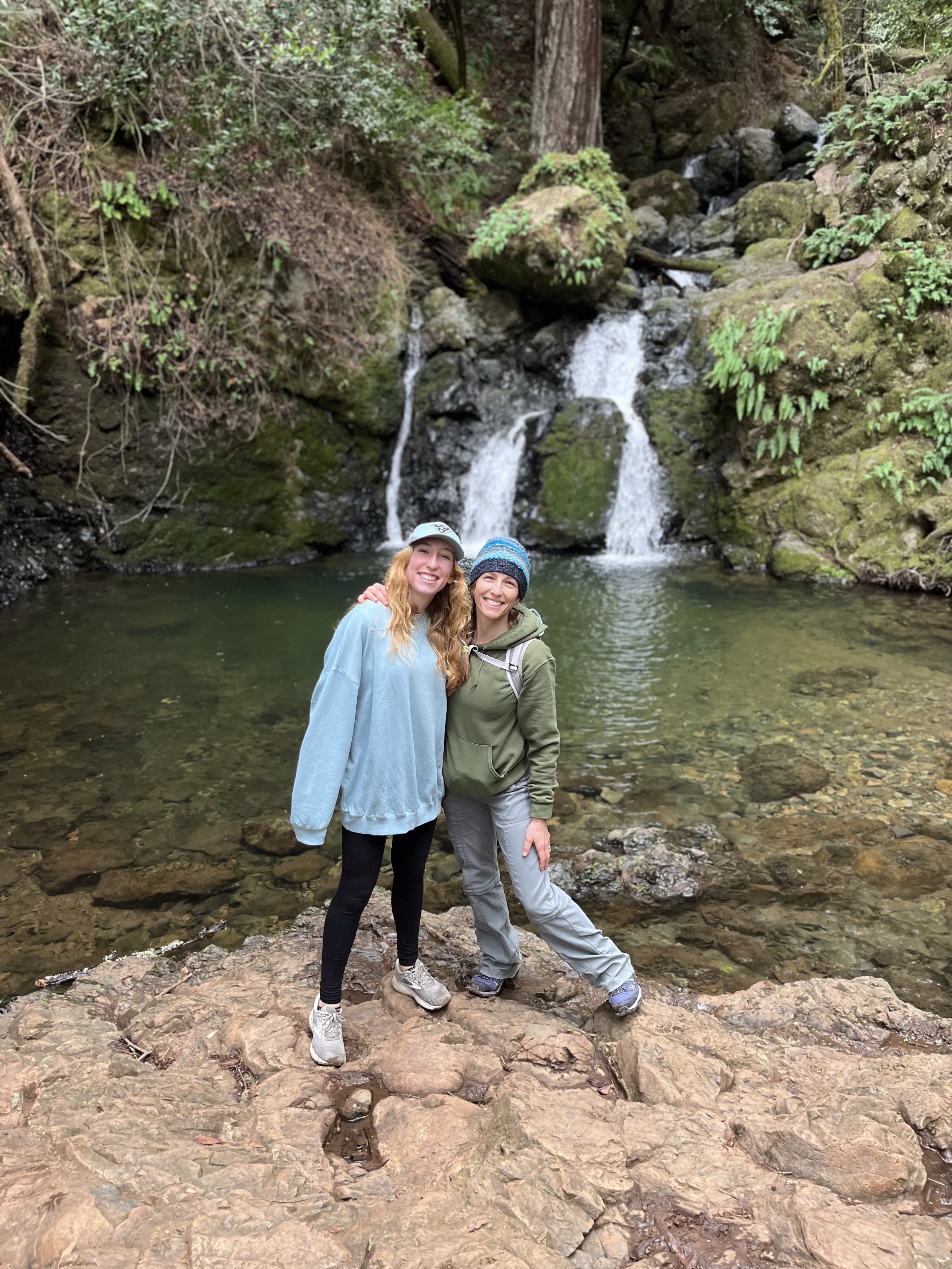 Life lessons for daughters standing at waterfall